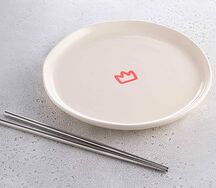 Бежевая тарелка и серебряные палочки