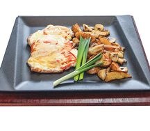 Свинина, запеченная с грибами и помидорами с сыром