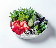 Розовые томаты и огурцы с чесночным соусом и карибикой