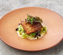 Муксун с брюссельской капустой, черемшой, спаржей и чипсами из нори