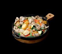 Горячая сковорода с курицей и грибами в сливочном соусе