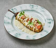 Печеный баклажан с томатами в ореховом соусе с сыром сулугуни и зеленью