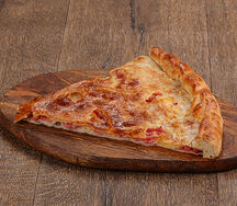 Кусок осетинского пирога с ветчиной и сыром