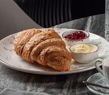 Хрустящий круассан с конфитюром из вишни и сливочным маслом