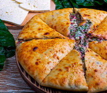 Осетинский пирог с сыром, зеленью и листьями свеклы 30 см