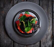 Салат с лососем и чипсами из риса с чернилами каракатицы