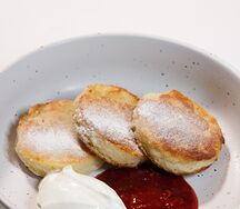 Сырники из рикотты с малиновым вареньем и сметаной