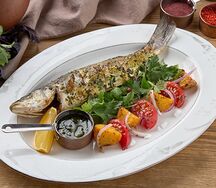 Целый сибас с мангала с помидорами и картофелем