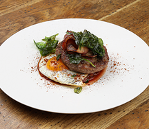 Бифштекс с глазуньей, пряной фасолью и жареным беконом