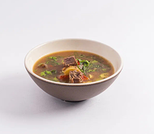 Наваристый суп с печёными овощами, томлёными щёчками и пряной зеленью