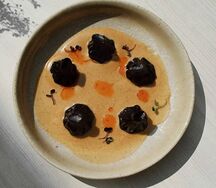 Черные мини-хинкали с уткой и перечным соусом 