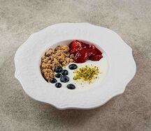 Йогурт с гранолой, клубничным соусом и голубикой