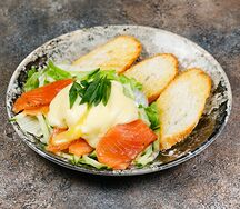 Салат со слабосолёным лососем, яйцом пашот и фирменным соусом 