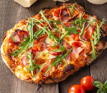 Пицца с рукколой, черри, пармской ветчиной 
