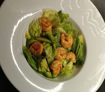 Микс из авокадо, тигровых креветок, хрустящих огурцов и зеленого лука с рукколой