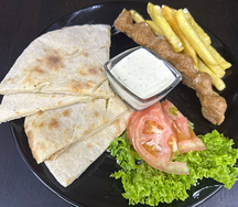 Сувлак на тарелке с люля из курицы